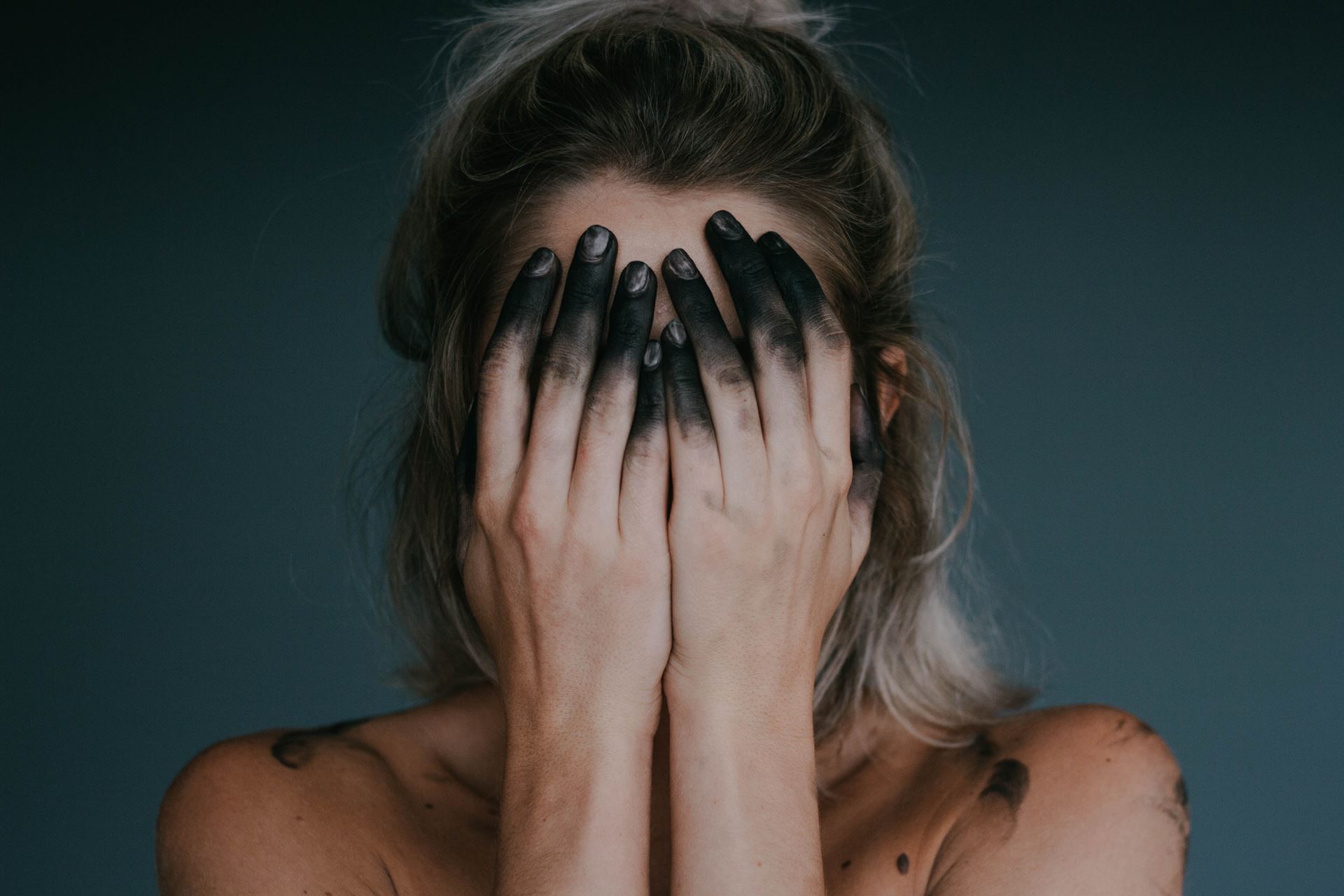 a woman covering her face with her hands